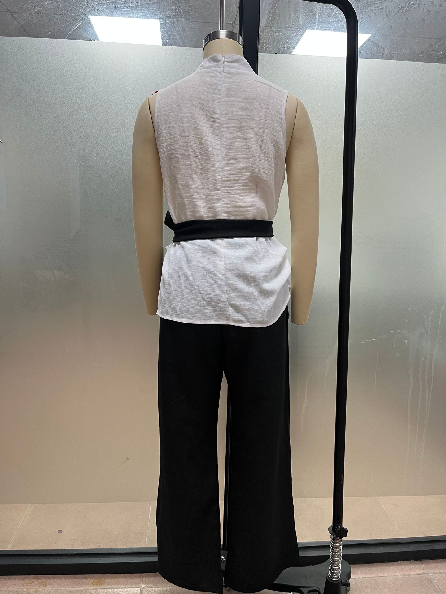 Women's lace-up sleeveless top and wide-leg pants set in white – lace-up detail close-up