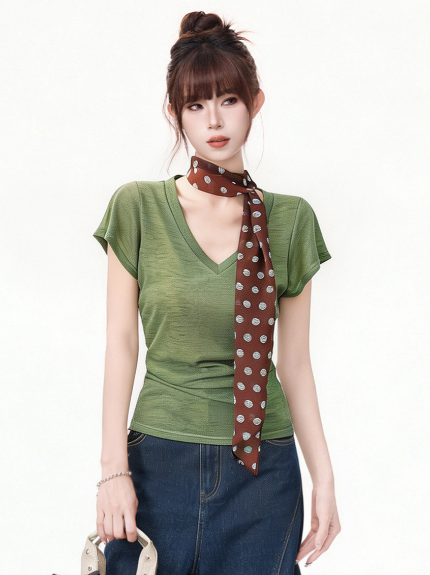 Close-up of splicing detail on moss green top