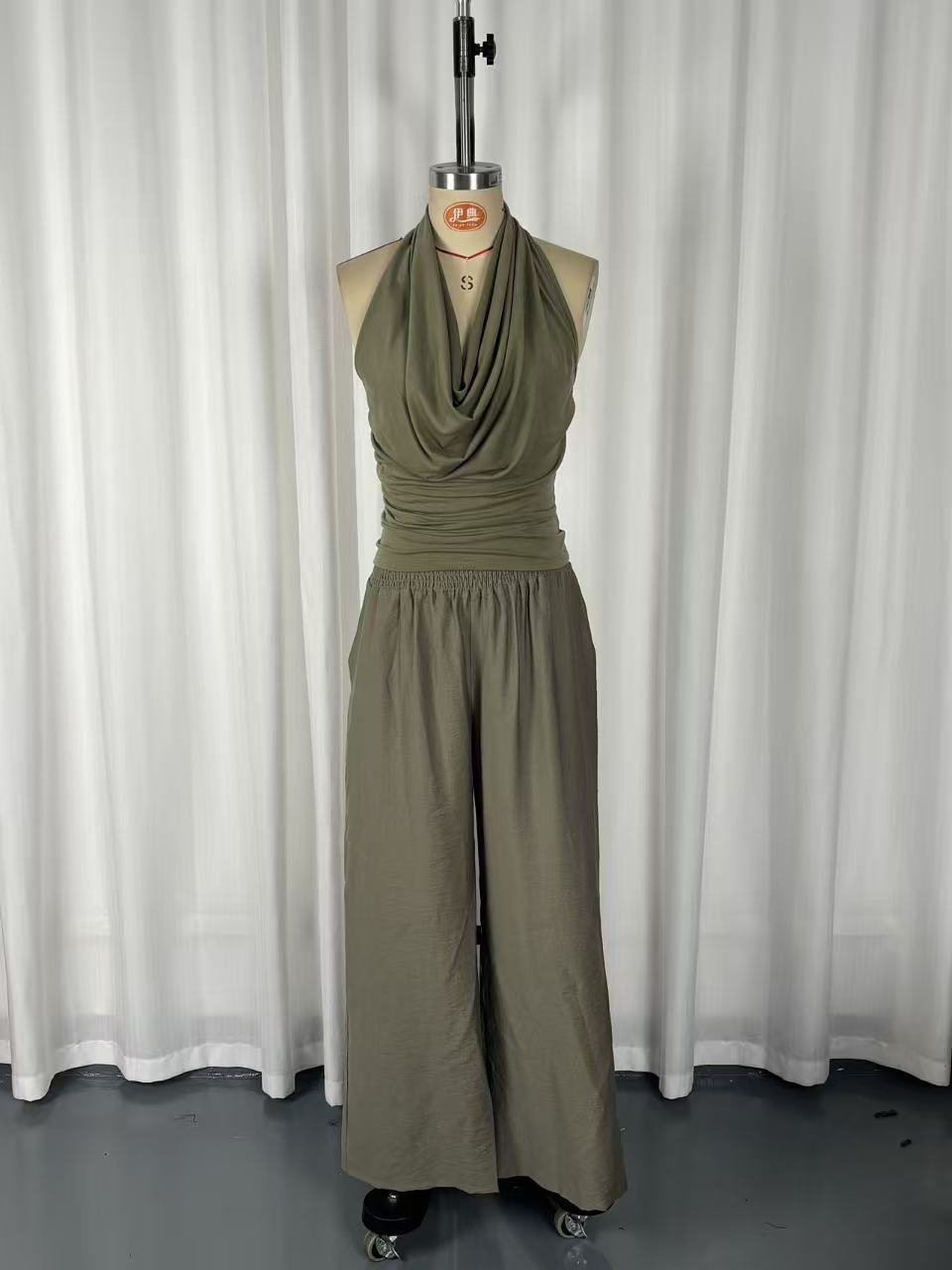 Green halter neck sleeveless top – loose wide leg pants two-piece set detail