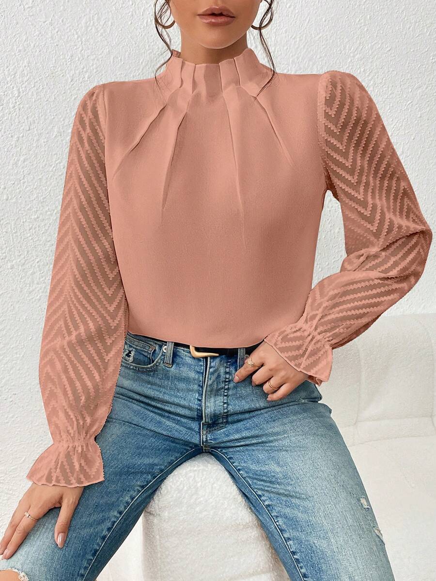 Women's mock neck chiffon top styled with belt and bag