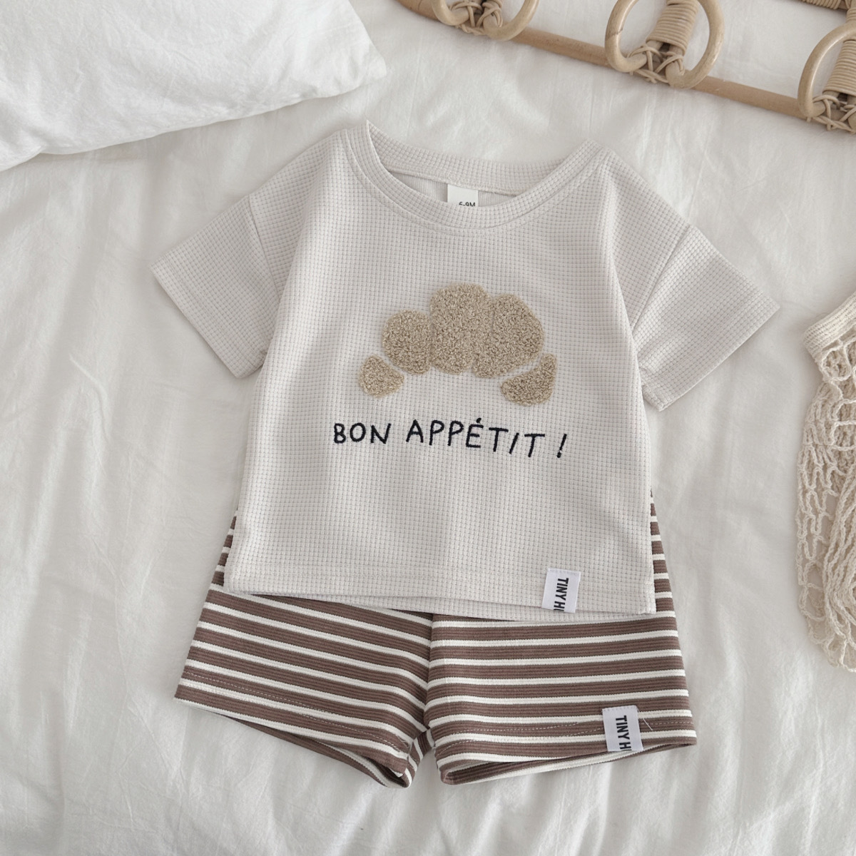 Two piece set of apricot colored short sleeved casual shorts with croissant patch fabric
