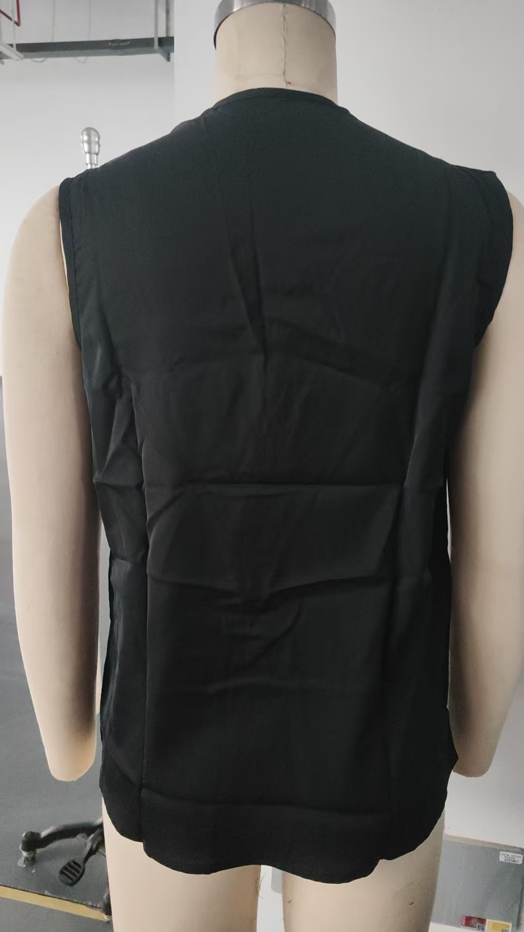 Women's surplice tank top V-neck and pleated panel close-up