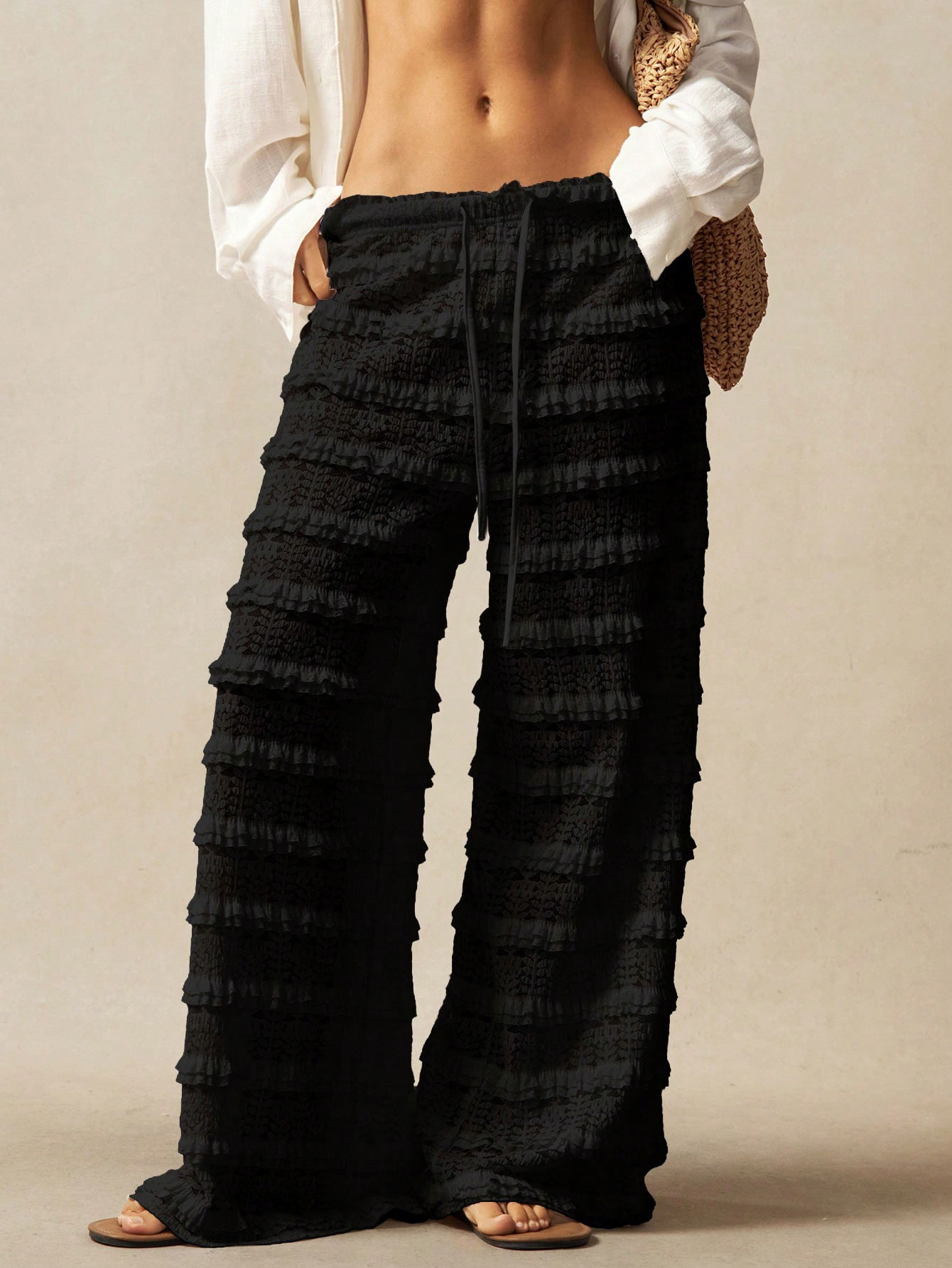 Women's lace pants waistband and tie-up detail close-up