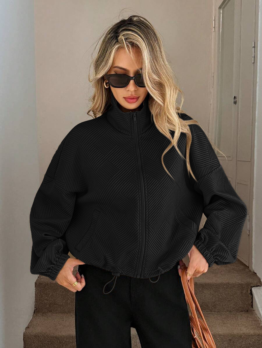Black zip-up jacket – back view showing relaxed oversized silhouette and ribbed hem