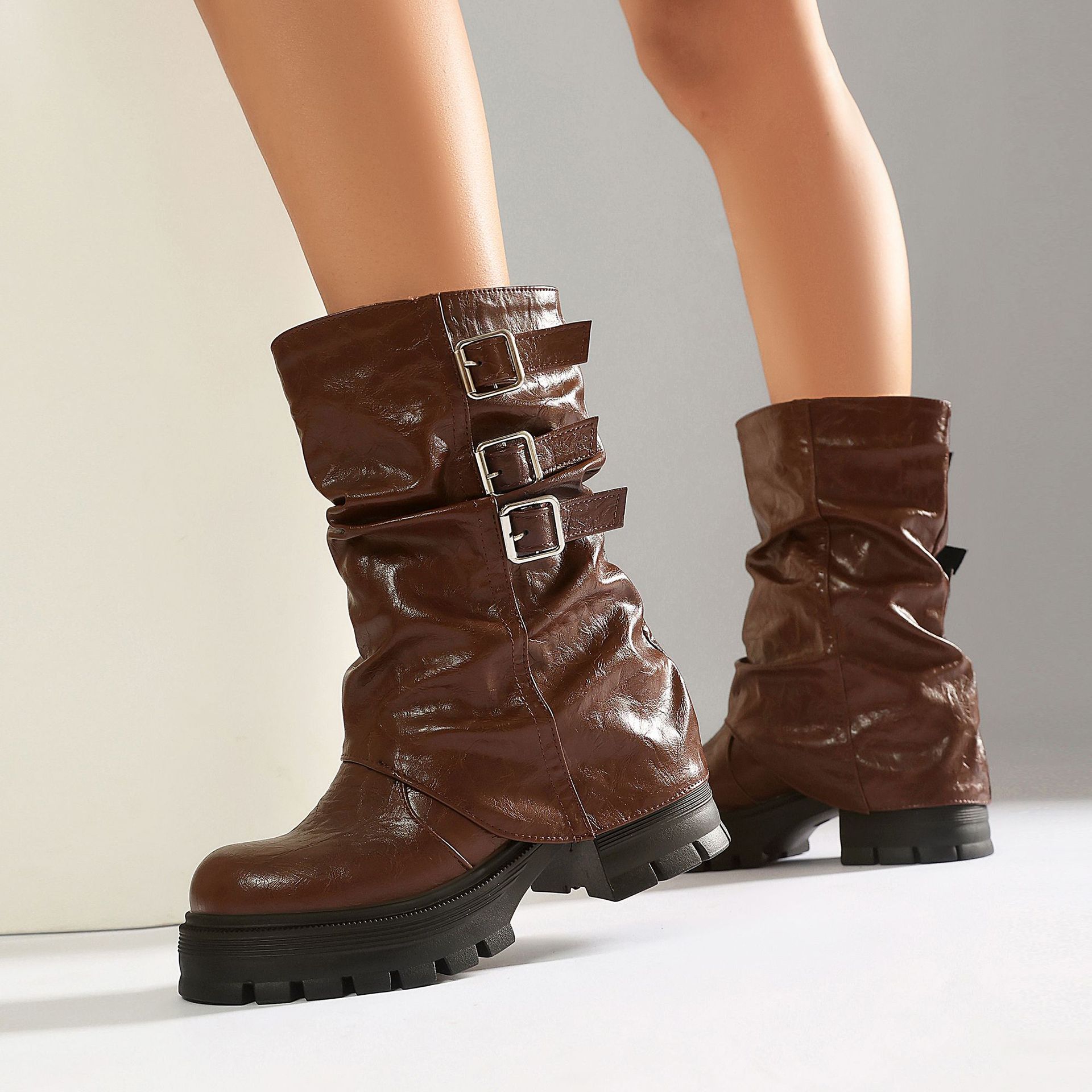 White punk slouchy boots – close-up of crinkled PU finish and silver square buckle strap detail