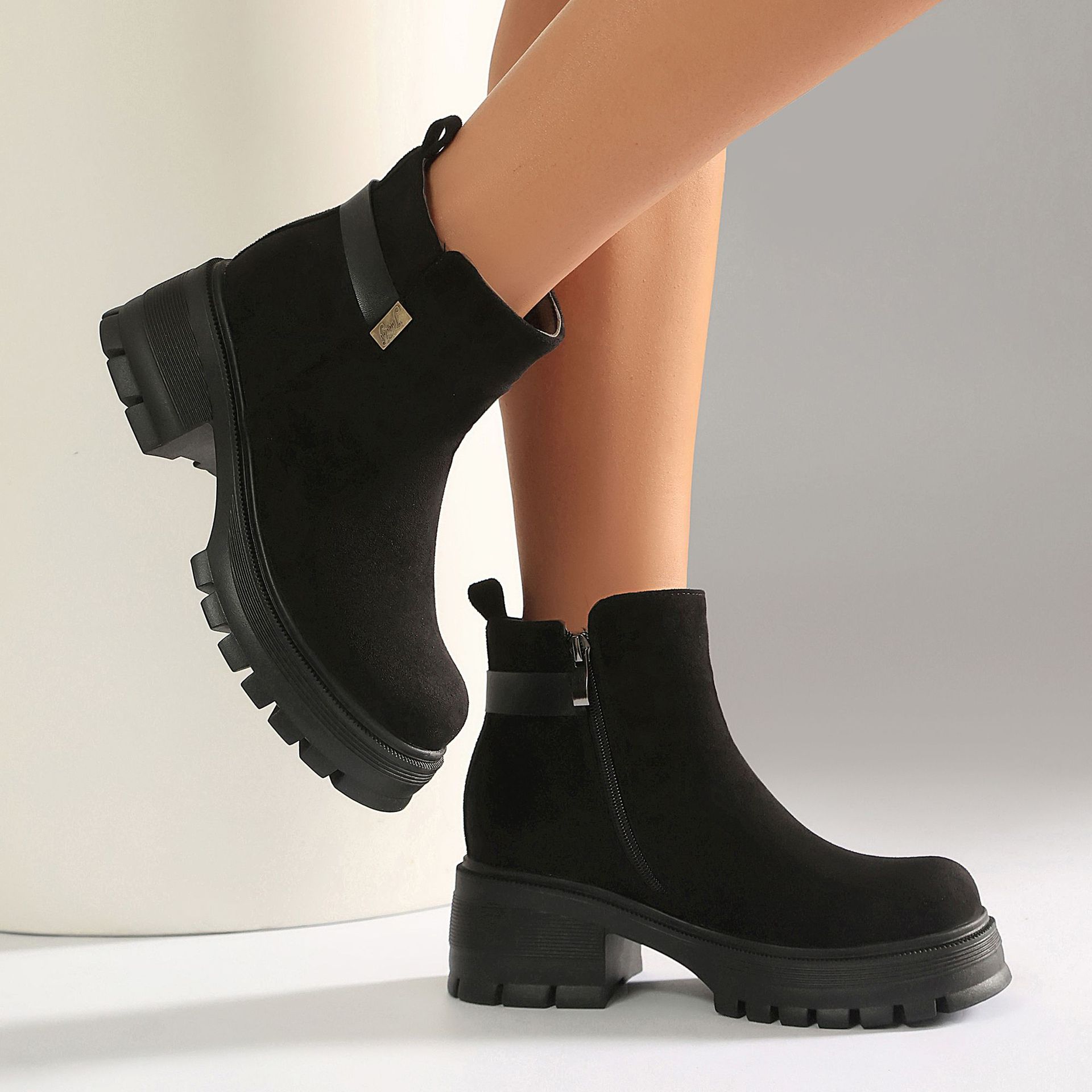 Black PU ankle boots – close-up of glossy PU finish and gold hardware strap detail