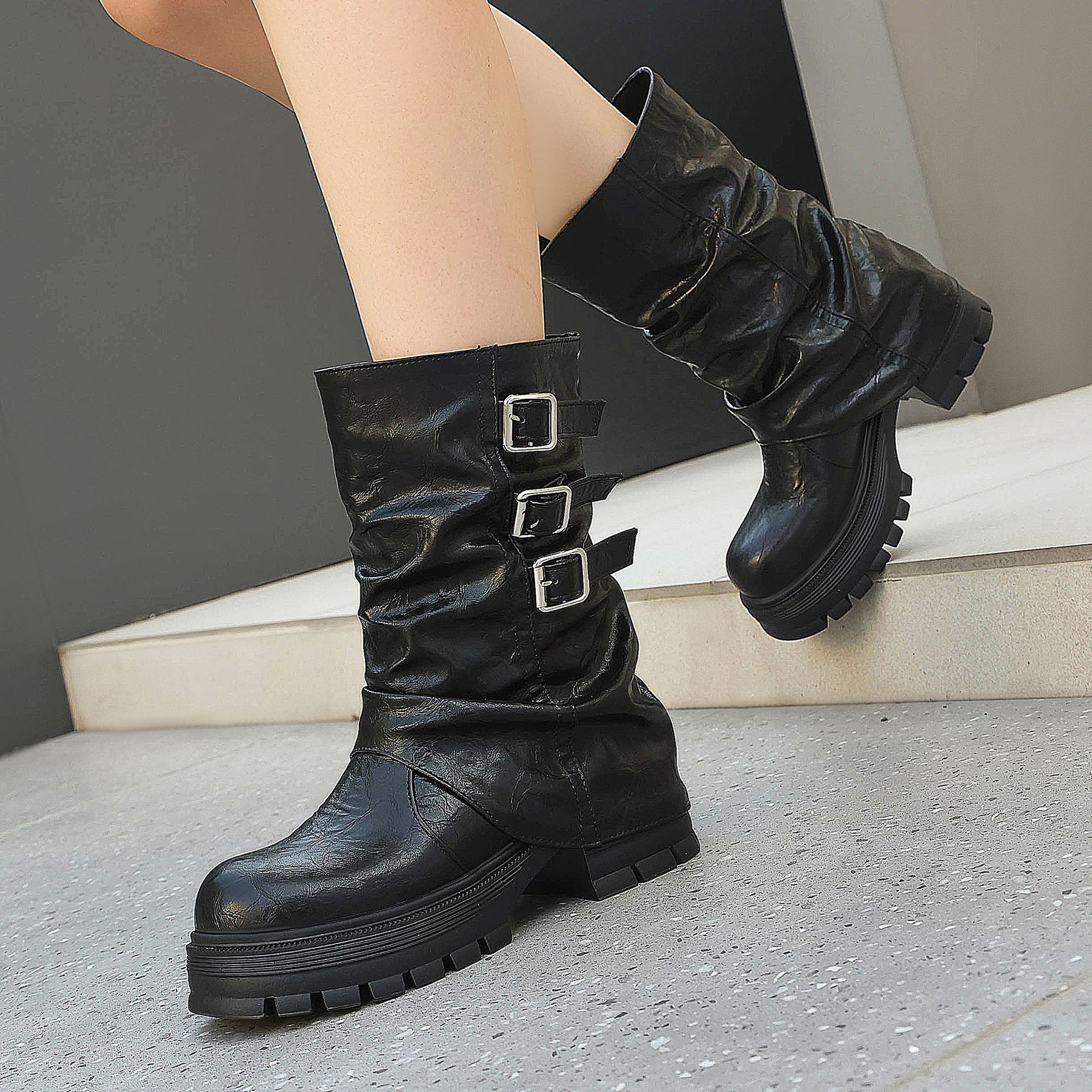 Black punk slouchy boots – editorial shot showing full boot silhouette against neutral background