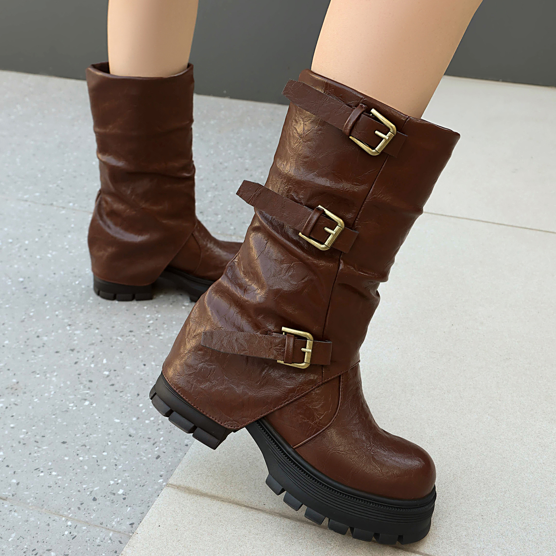 Size reference – women's triple buckle moto boots on model showing mid-calf shaft height and fit