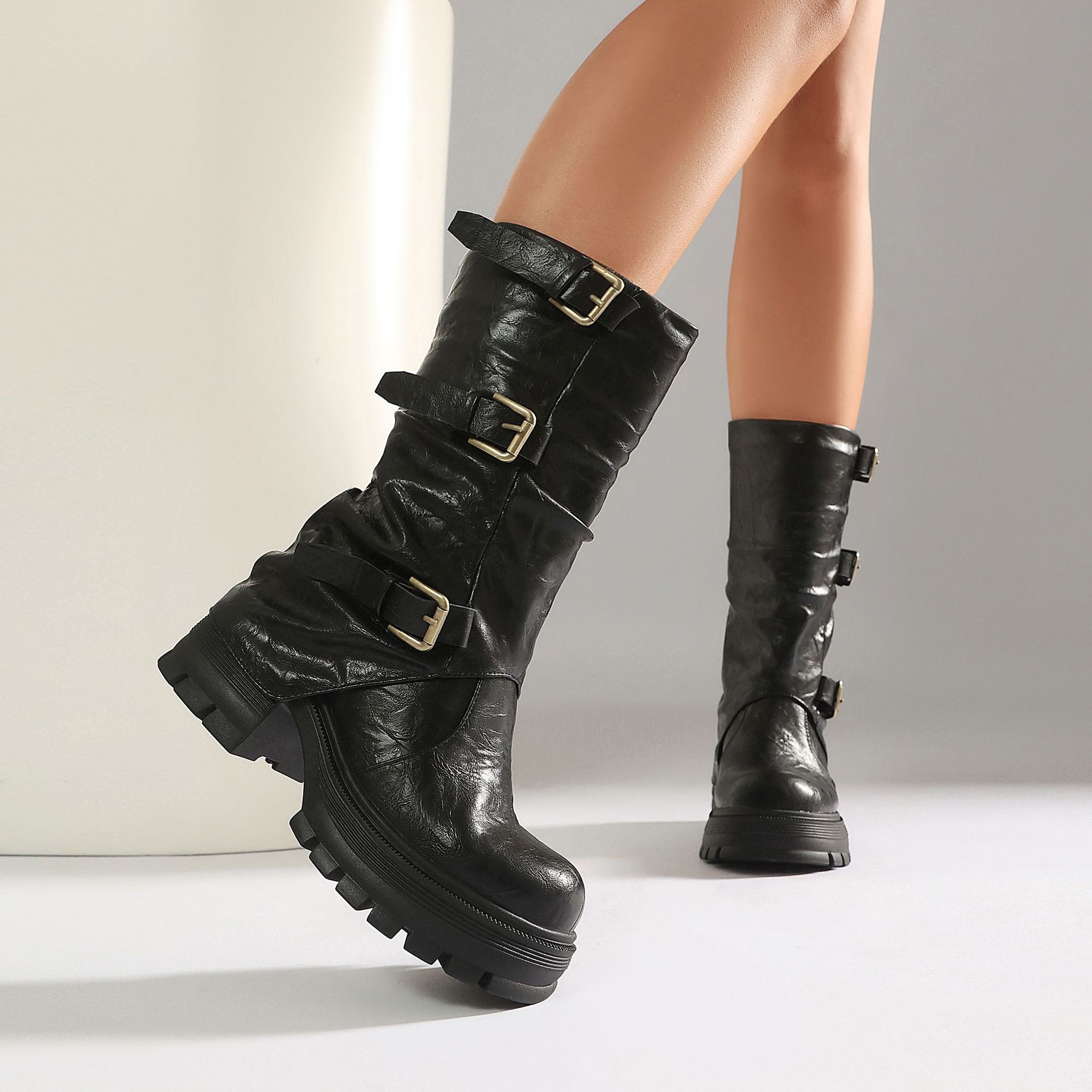 White triple buckle boots – close-up of distressed PU finish and antique brass buckle detail