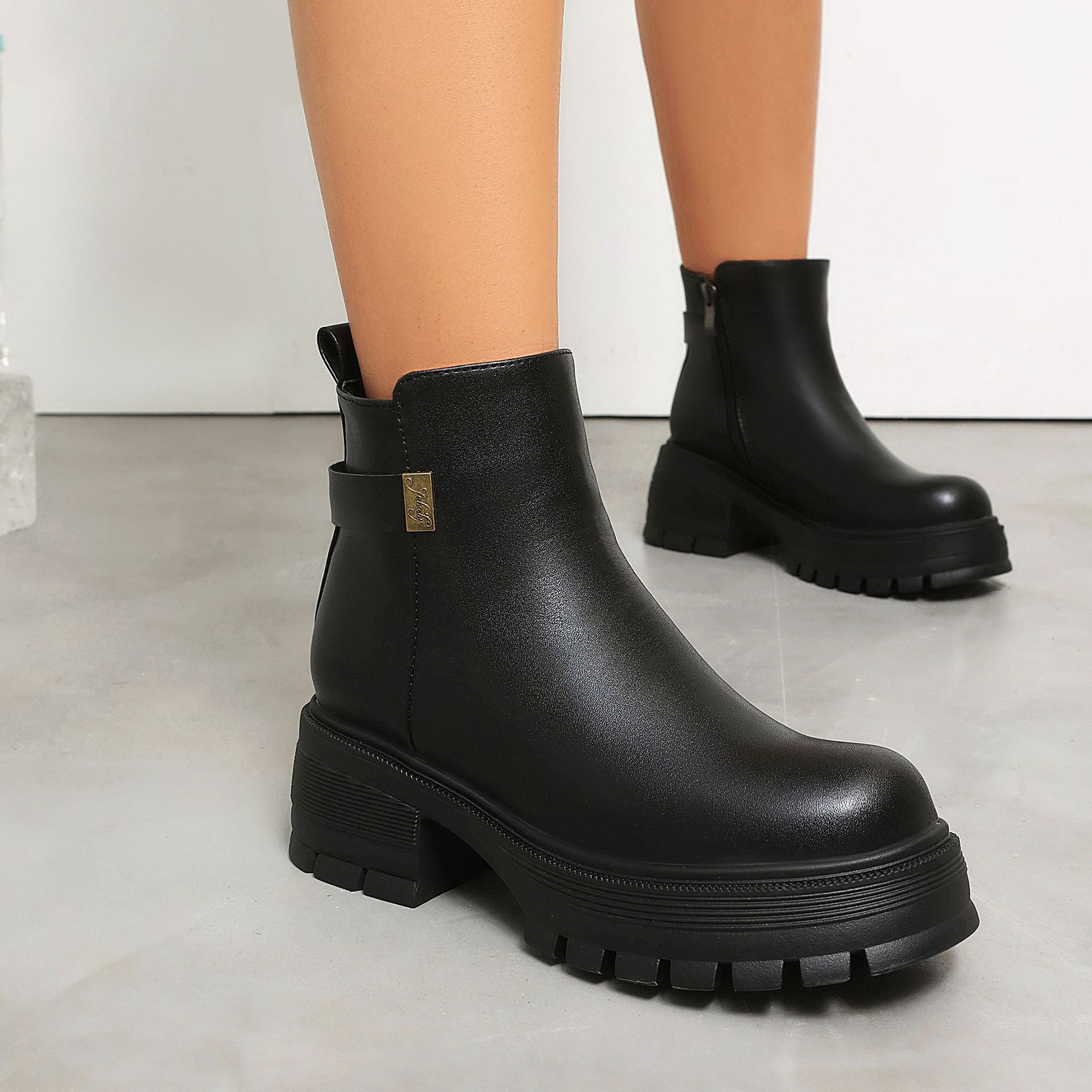 Black PU ankle boots – lifestyle shot styled with outfit showing full boot silhouette