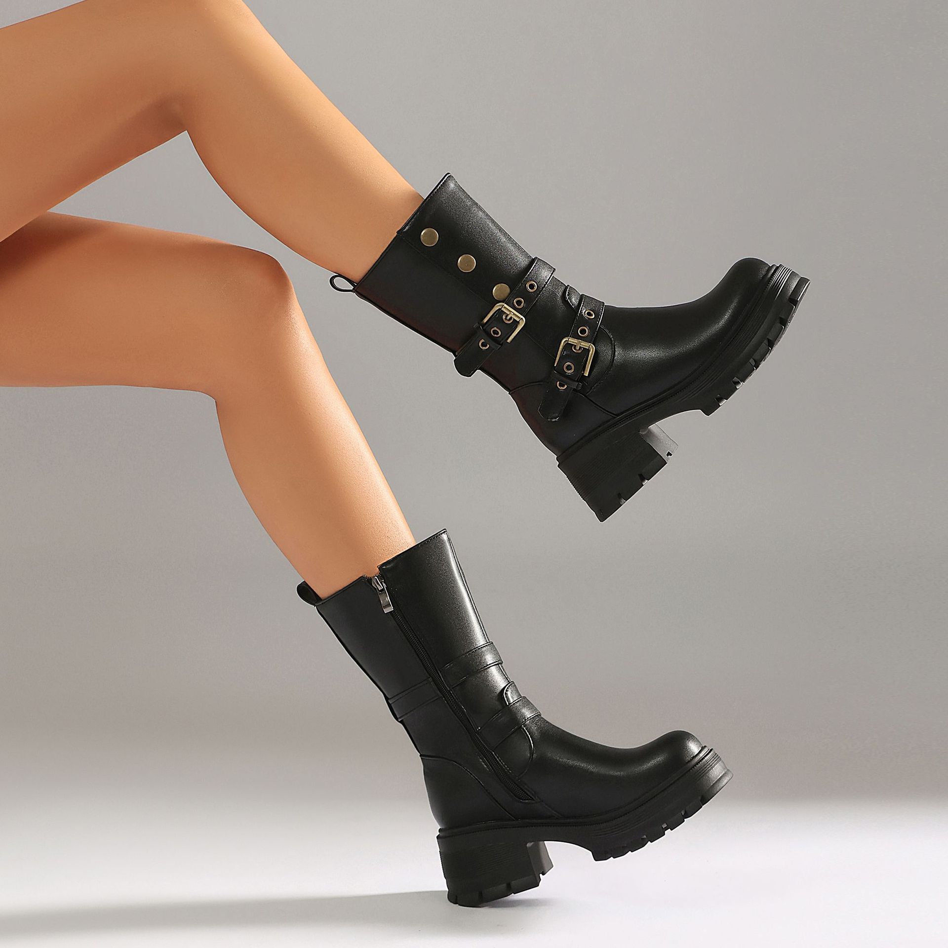 Black faux suede moto boots – front view on model showing full boot and outfit styling