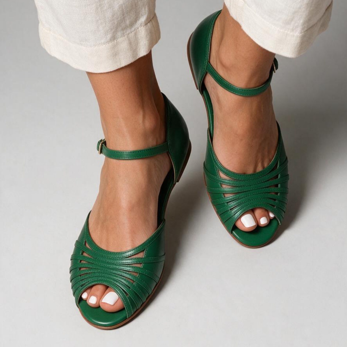 Green flat sandals – close-up of cut-out multi-strap peep-toe front and ankle strap detail