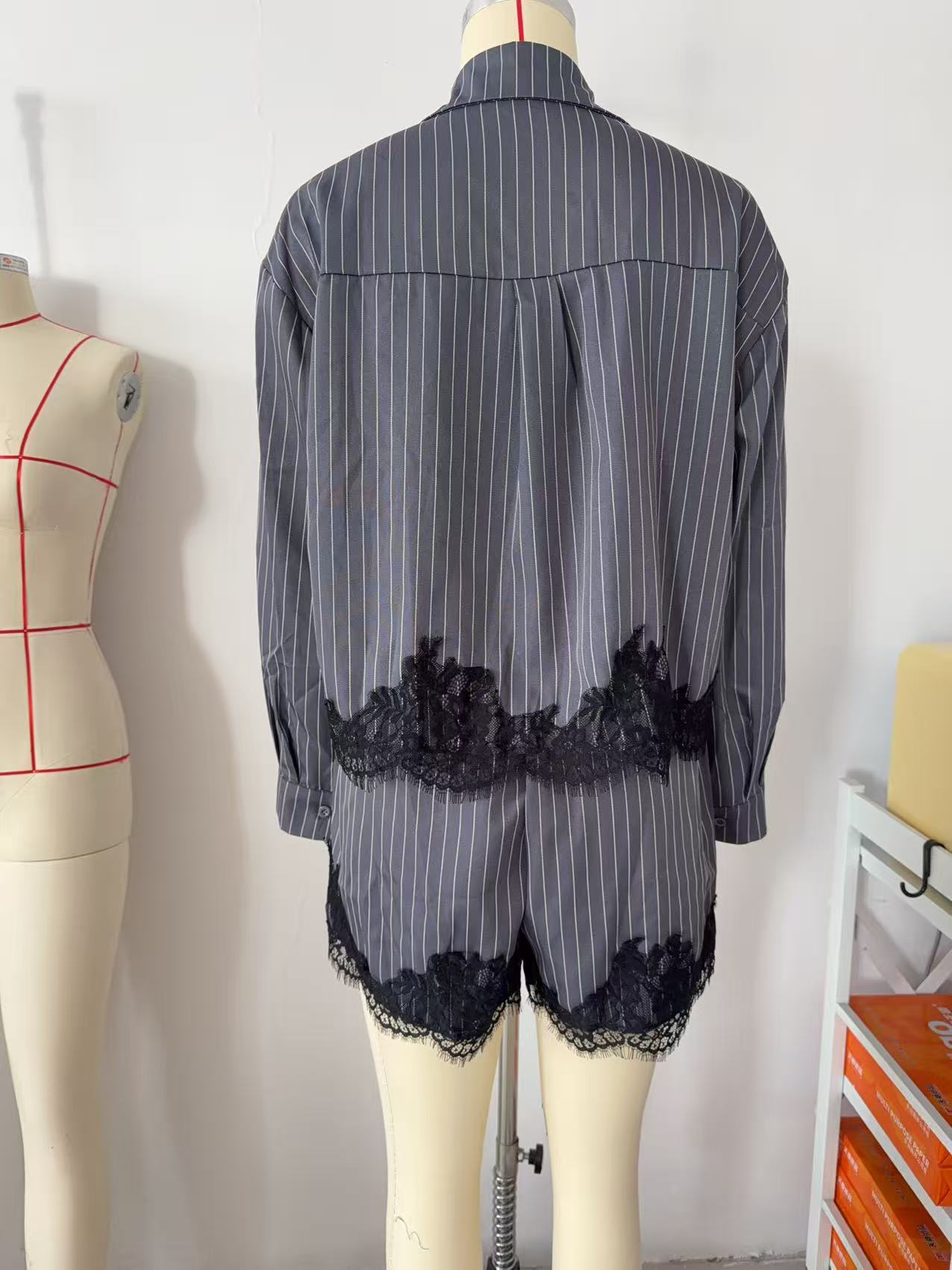 Striped lace trim shirt – close-up of black lace hem and button placket detail