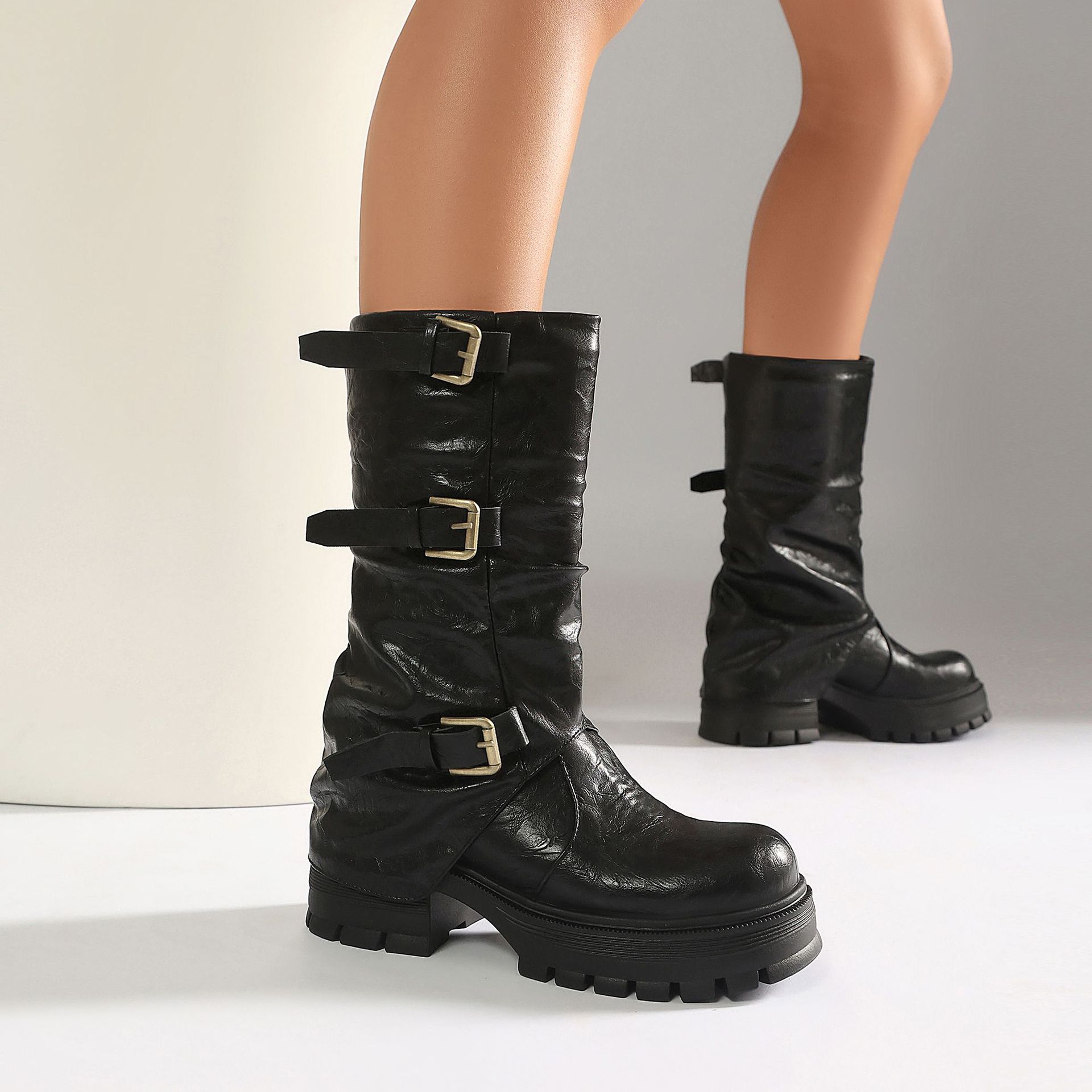 Black moto boots – front view on model showing full boot and outfit styling