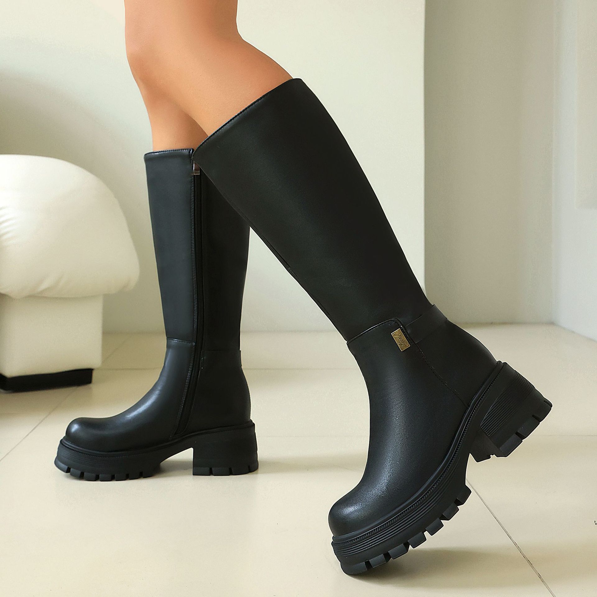 Women's chunky heel boots – back view showing side zipper and lug sole platform
