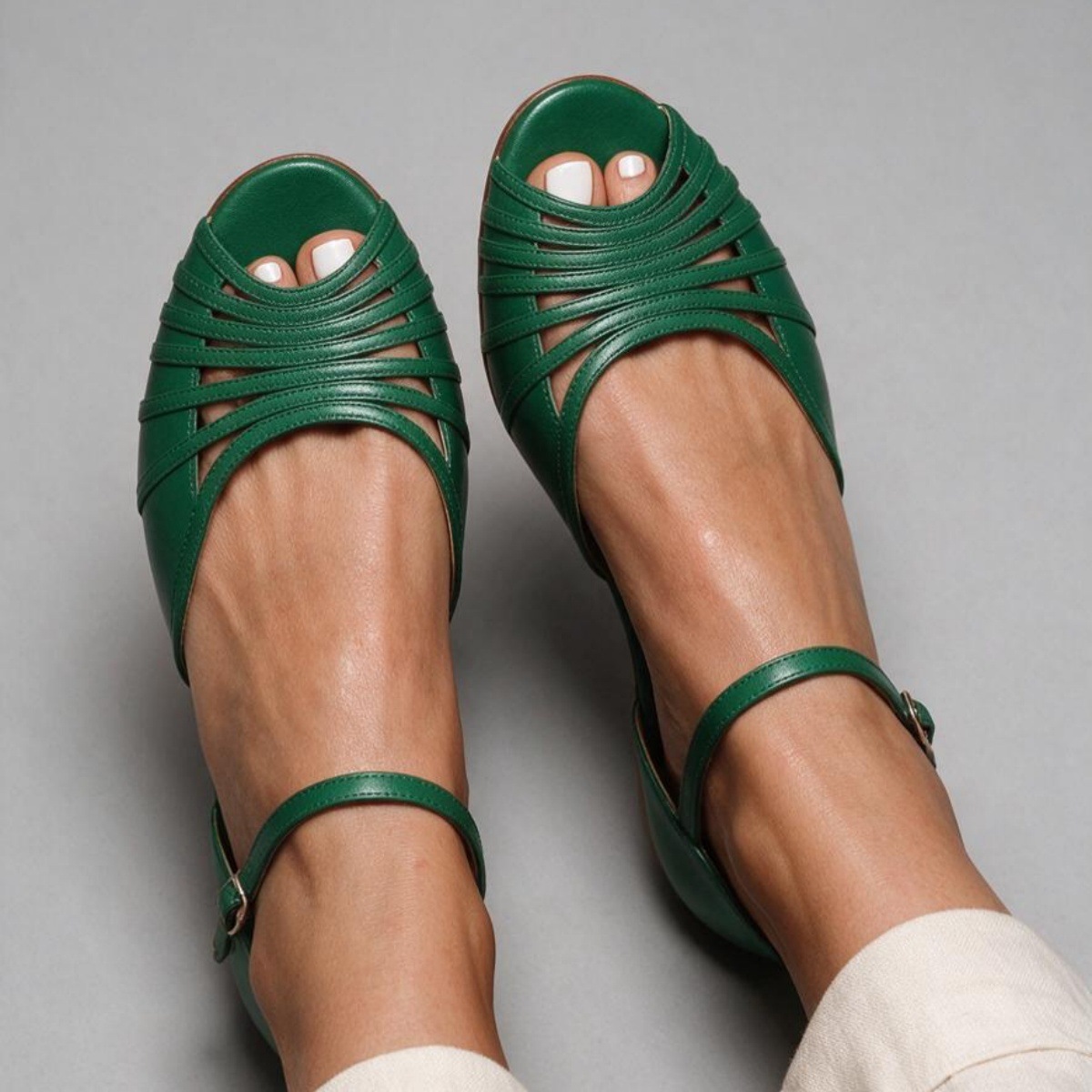 Women's green cut-out peep-toe flat sandals – styled on model showing full sandal and summer outfit