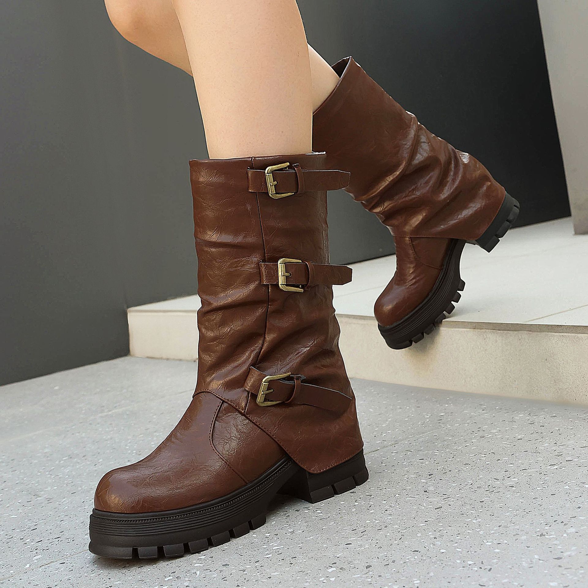 Brown triple buckle moto boots – close-up of antique brass buckle straps and distressed PU shaft