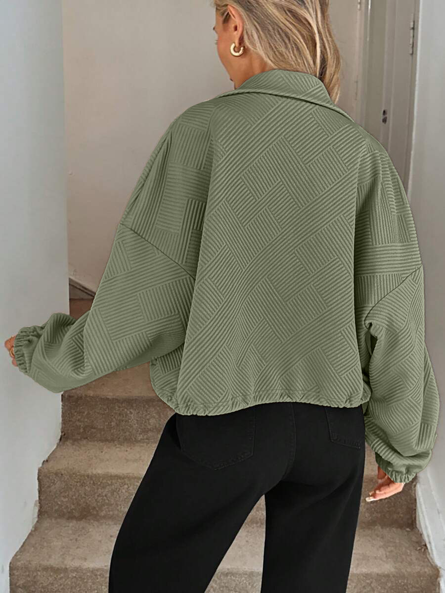 Khaki zip-up jacket – close-up of textured fabric and ribbed cuff detail