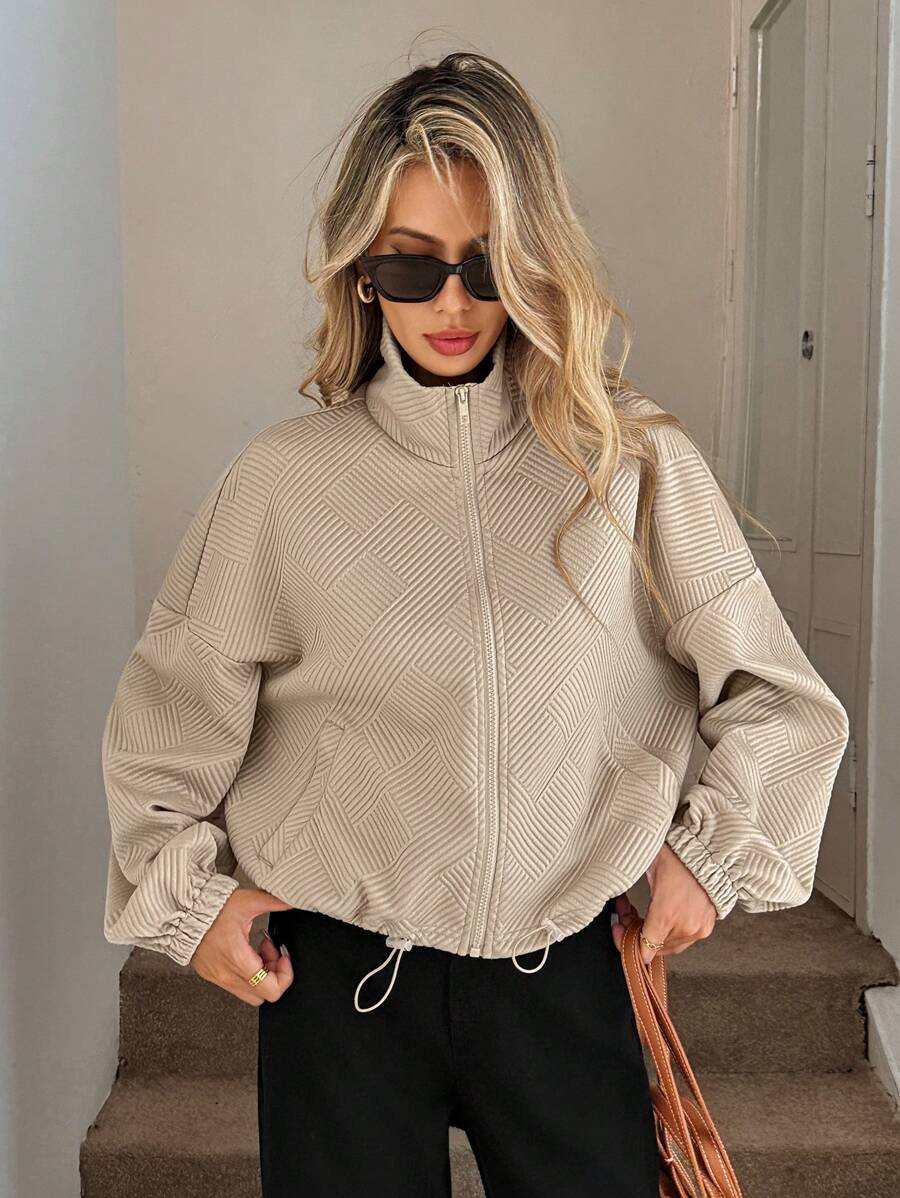 Khaki women's jacket – lifestyle shot styled with wide-leg trousers and sneakers